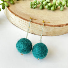 Load image into Gallery viewer, Teal pom pom drop earrings with gold post. Lightweight statement earrings that add a pop of color.
